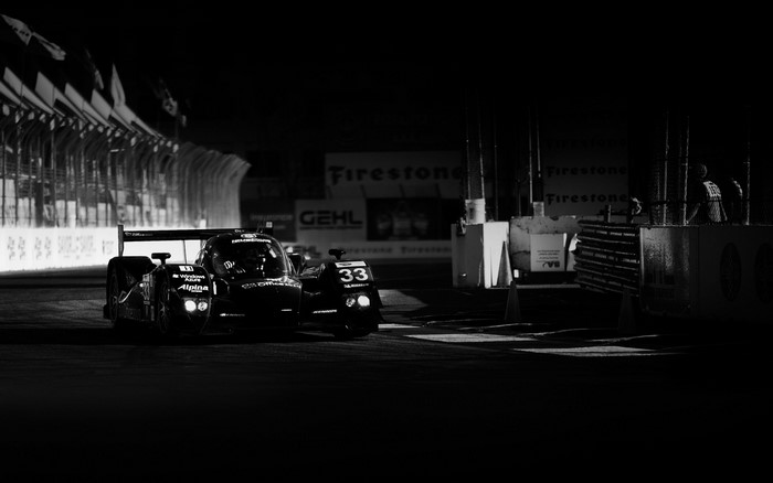Night race cars on track with Firestone signs