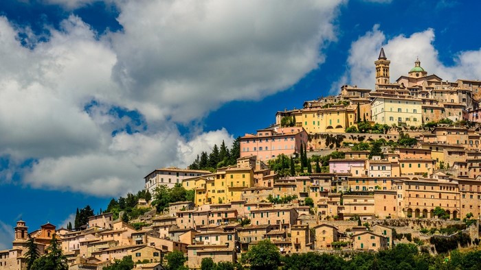 Hillside town with colorful buildings and a church tower