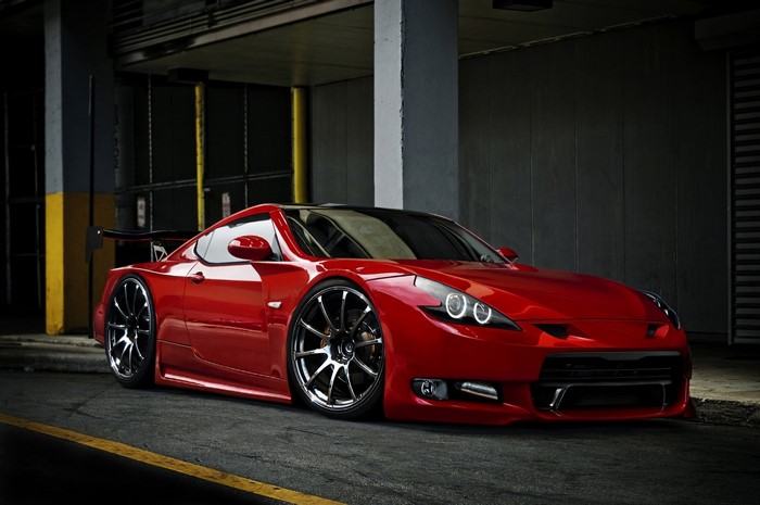 Red sports car with custom wheels and spoiler