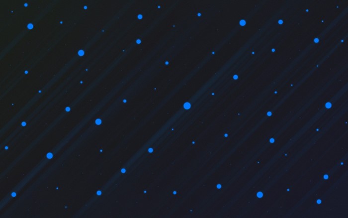 Abstract blue circles on dark background with light streaks