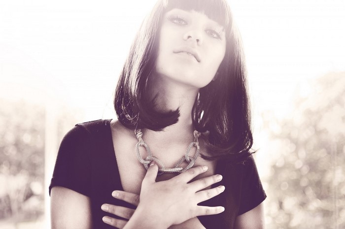 Woman with dark hair and necklace