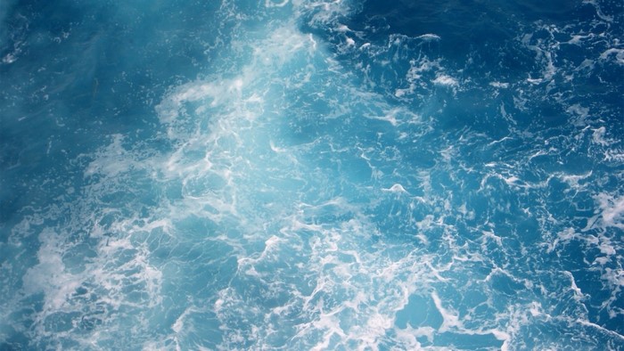 Blue ocean waves with sunlight