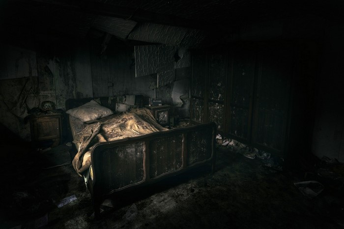 Dark and ruined bedroom interior at night