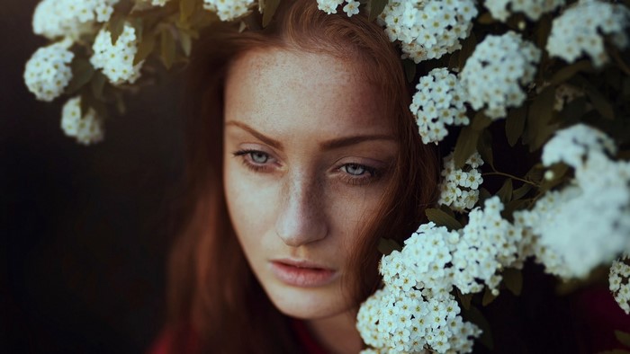 Woman with red hair and white flowers