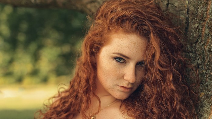 Redhead Woman with Freckles and Sensual Gaze