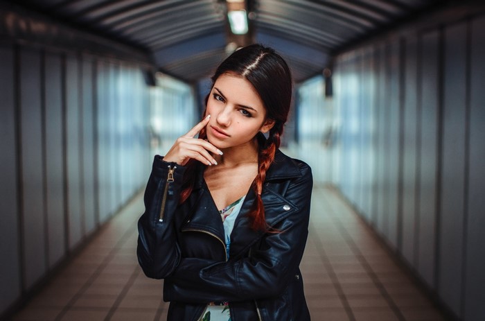 Woman with braids wearing a leather jacket