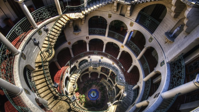 Spiral staircase in a circular building with a fountain