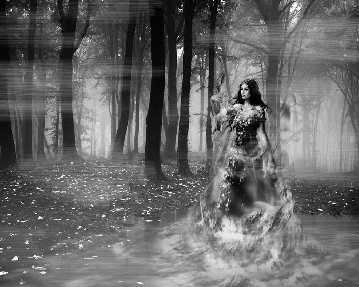 Ghostly woman in a misty forest