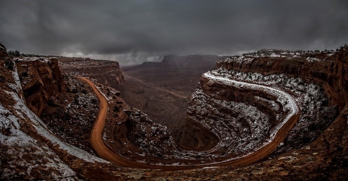Winding dirt road through a snowy canyon in Utah