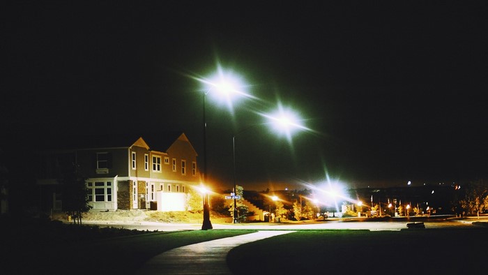 Street lights illuminate a suburban neighborhood at night