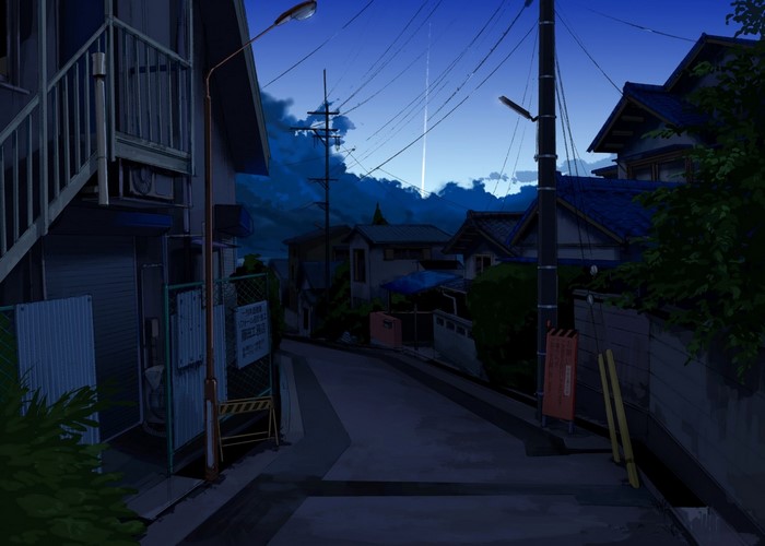 Residential street at dusk with houses and power lines