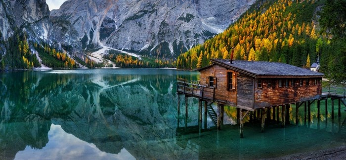 Serene Lake and Cabin in the Italian Alps