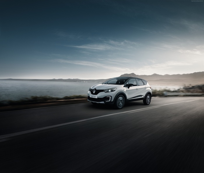 White Renault Kaptur driving on a coastal road