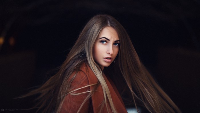 Woman with long brown hair and blue eyes