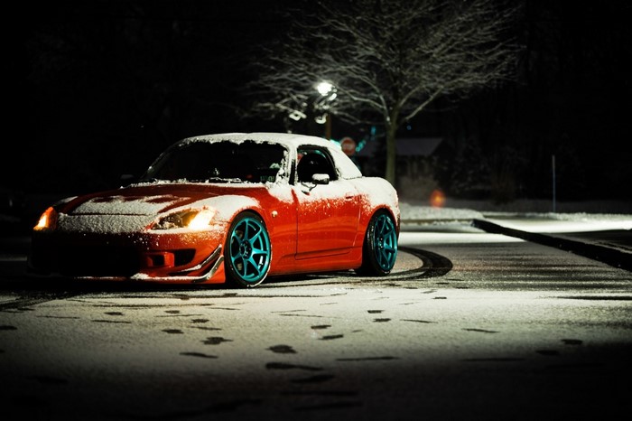 Red Honda S2000 with blue wheels in snow