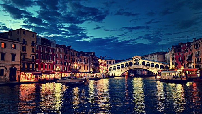 Venice cityscape at night with Rialto Bridge and canal