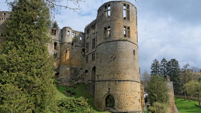 Ruined medieval castle tower with stone walls and windows