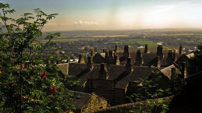 View of a village with many chimneys from a hill
