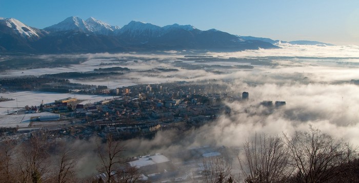 Misty valley with snow-capped mountains in Slovenia