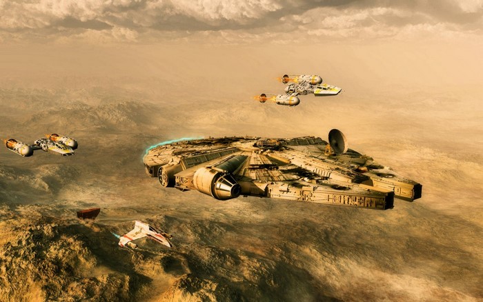 Millennium Falcon and Y-wings over desert terrain