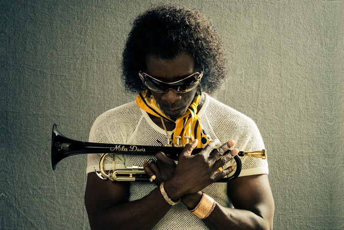 Miles Davis holding a trumpet