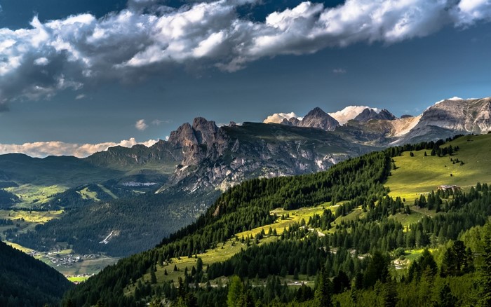 Dolomites Mountains landscape with green hills and forest