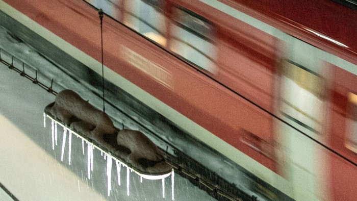 Train passing by icicles on a cold day