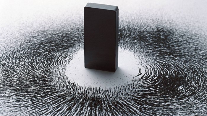 Magnet and iron filings showing magnetic field
