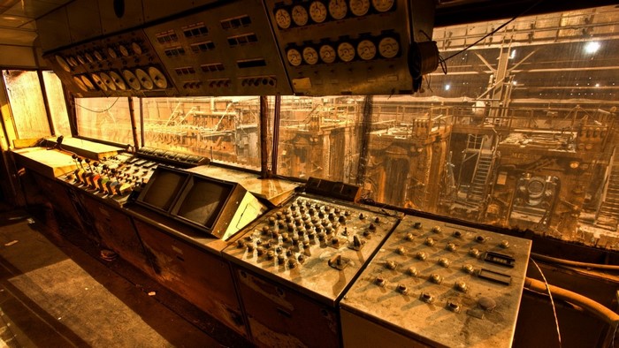 Industrial control room overlooking a factory floor