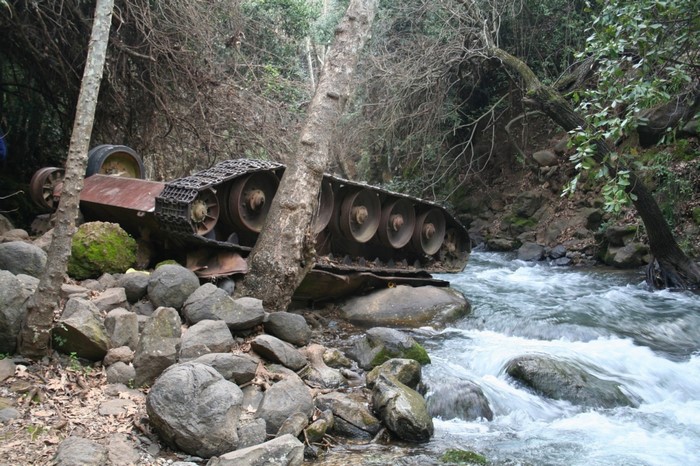 Abandoned tank wreck in a forest stream