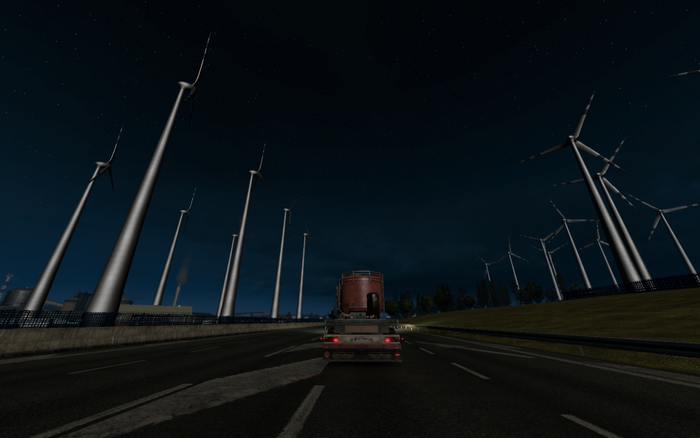 Euro Truck Simulator 2: Truck on highway at night with wind turbines