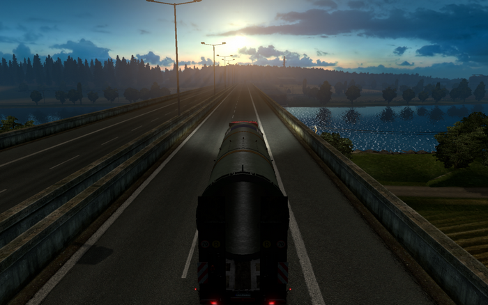 Truck driving on a highway at sunset in Euro Truck Simulator 2
