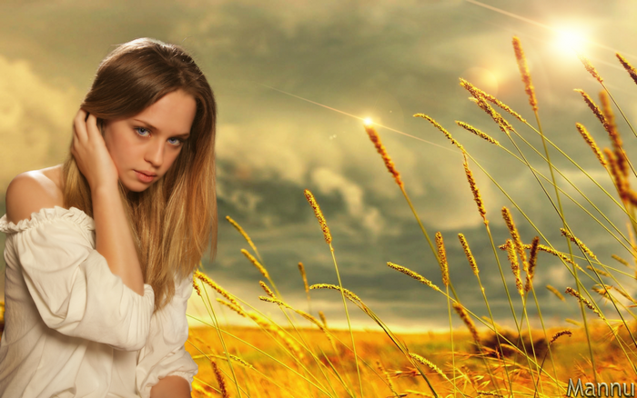 Woman in a wheat field at sunset