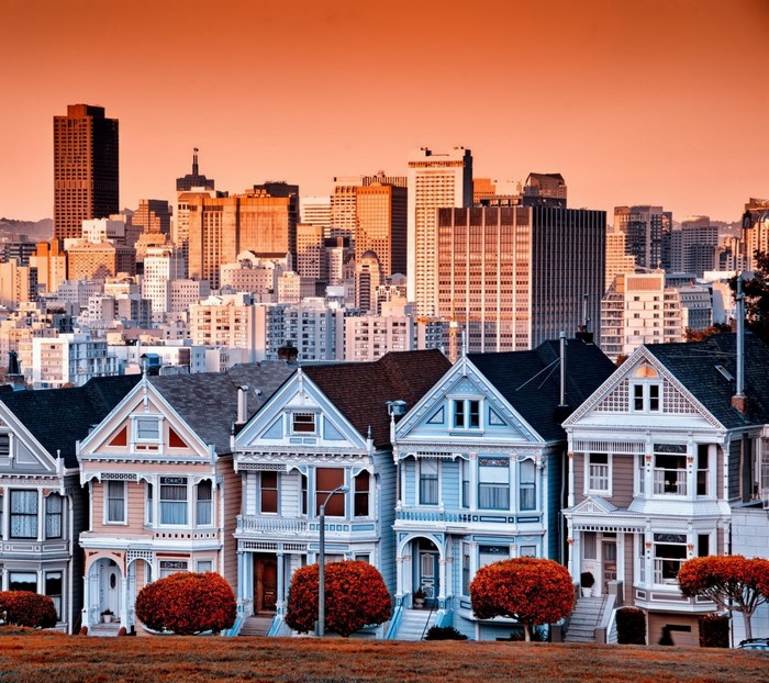 Painted Ladies Victorian houses with San Francisco skyline at sunset
