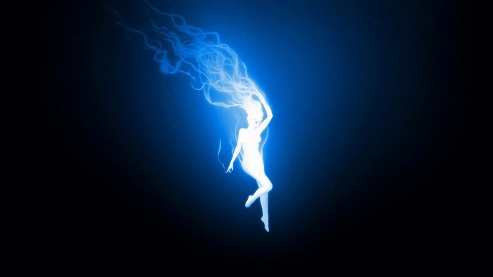 Woman with blue energy hair in darkness