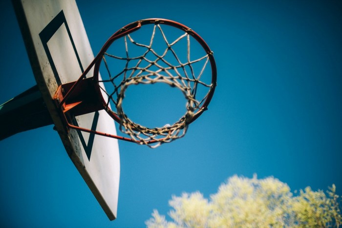 Basketball hoop against a blue sky