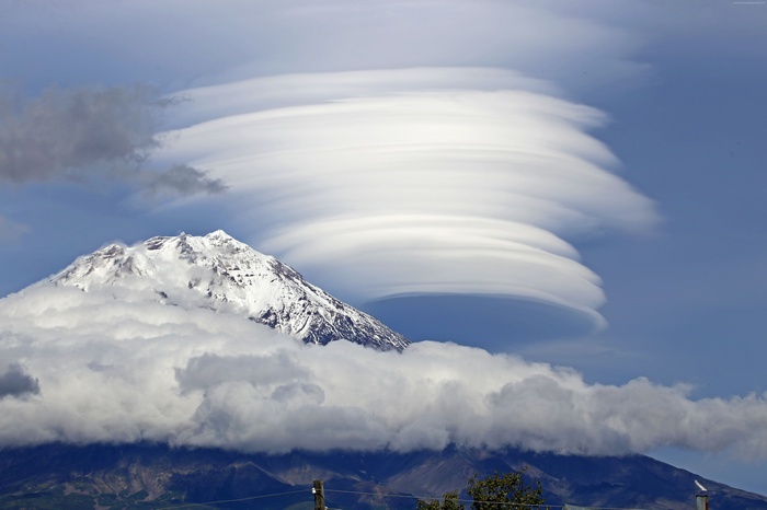Snow-capped mountain with lenticular clouds
