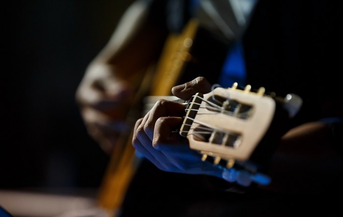 Close-up of a person playing a guitar
