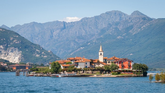 Island village with church tower and mountains