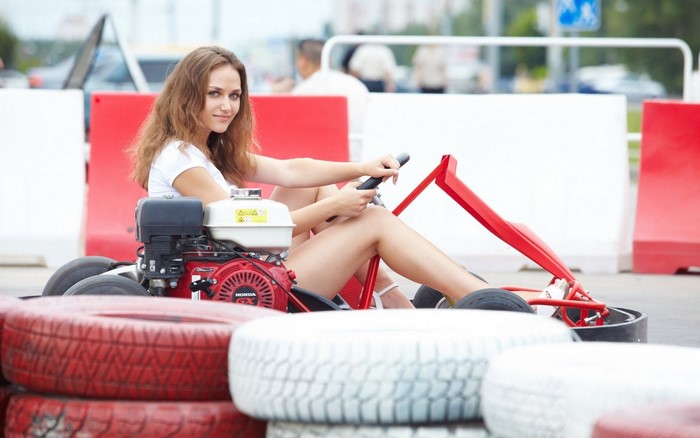 Woman driving a go-kart with red tires