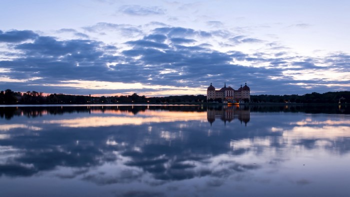 Castle reflection on lake at dusk