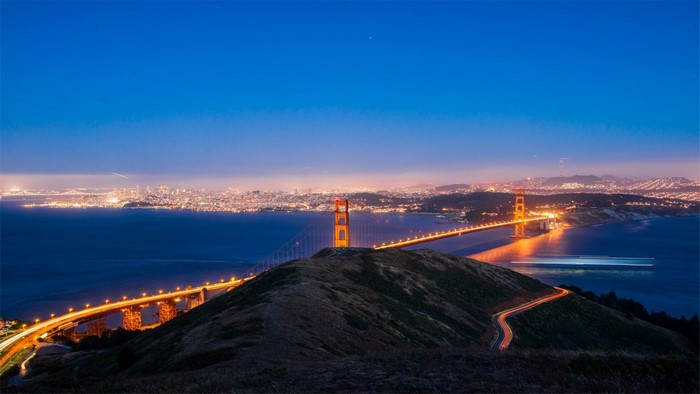Golden Gate Bridge at night with San Francisco skyline