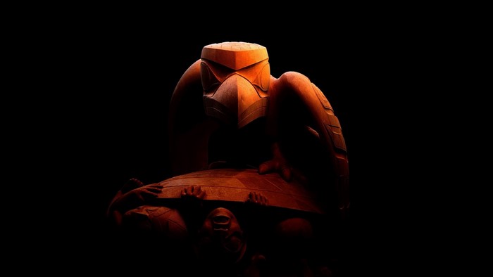 Wooden sculpture of a raven on a turtle