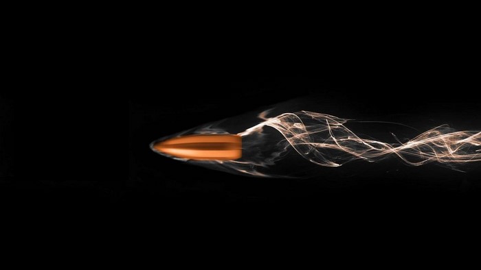Bullet in flight with smoke trail