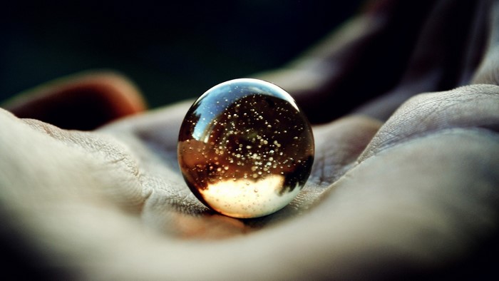 Marble with bubbles held in a hand