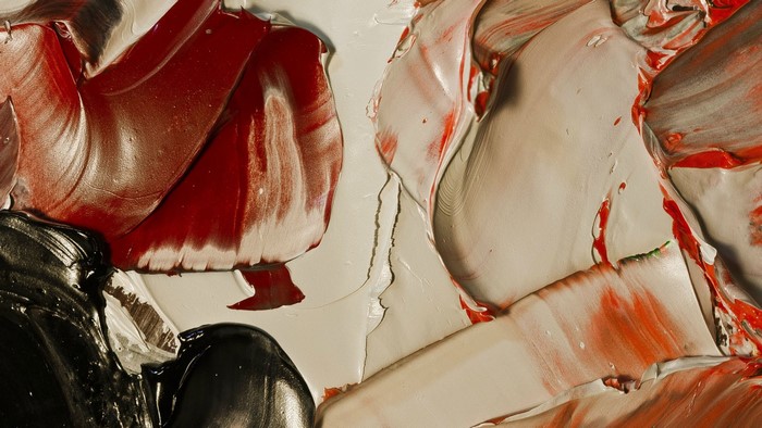 Abstract painting with thick impasto strokes of red, black, and cream paint