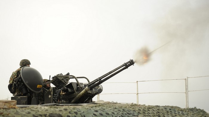 Soldier firing a Gatling gun