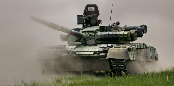Russian Army T-80 tank in dust and grass