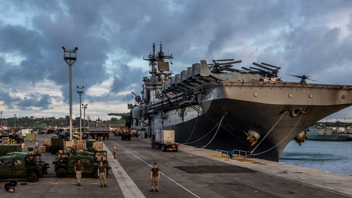 Amphibious Assault Ship docked with military vehicles and personnel