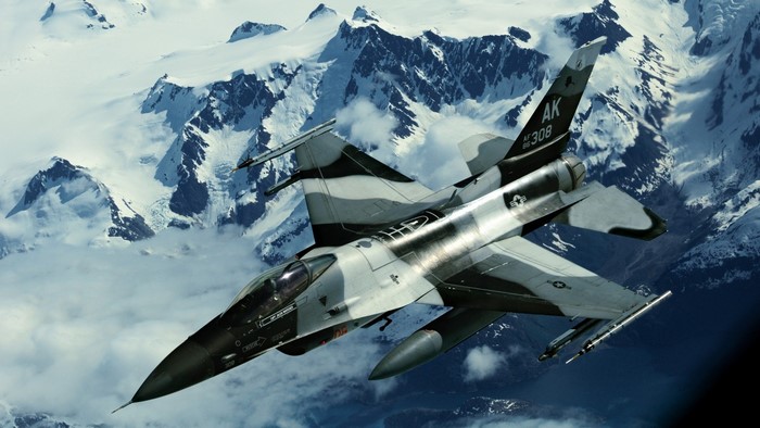 F-16 Fighting Falcon flying over Alaskan mountains